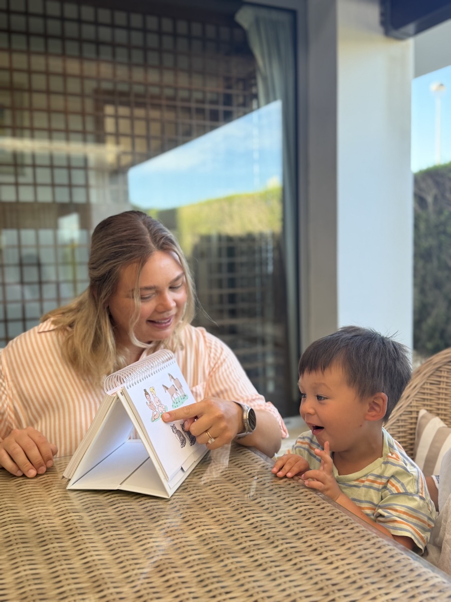 Aemelia Jackson guiding a young client through an articulation activity during a speech therapy session